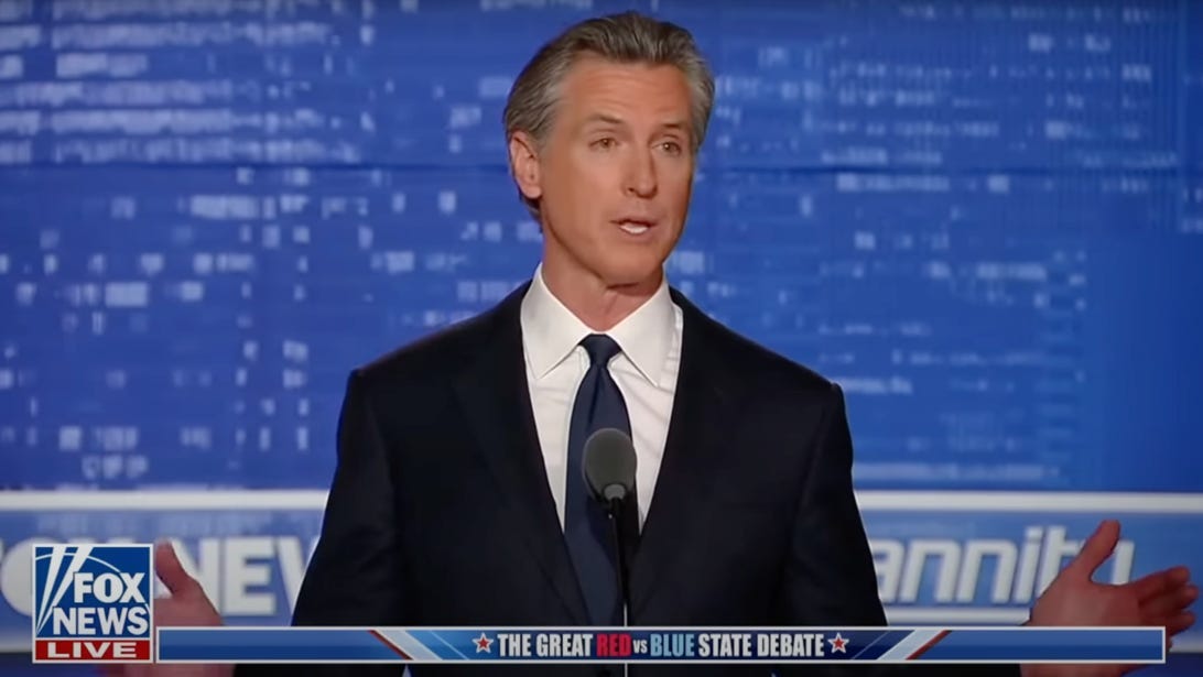 A person in a suit and tie

Description automatically generated