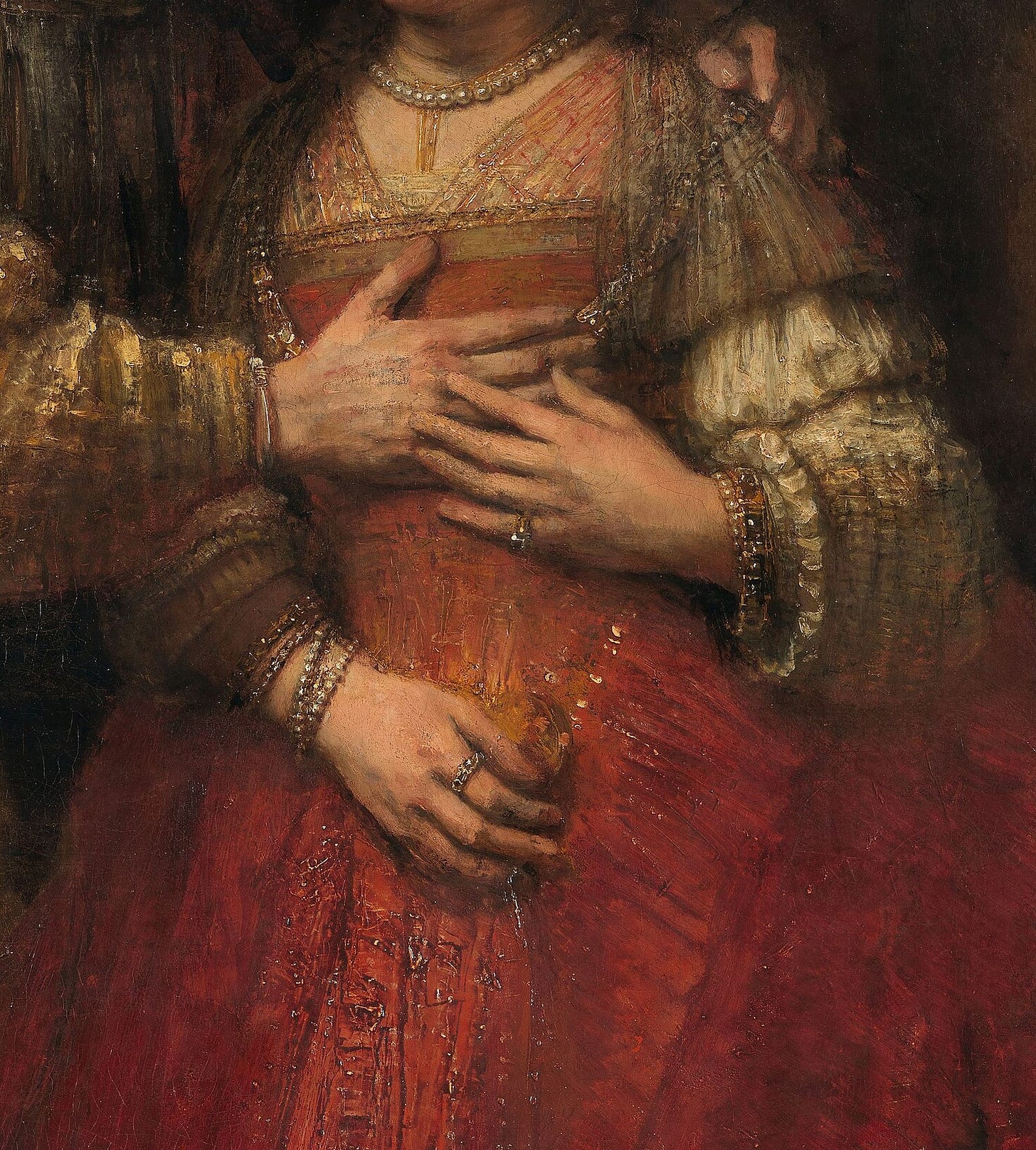 Detail of The Jewish Bride by Rembrandt: the couple's hands resting on the bride's red dress, painted in thick impasto