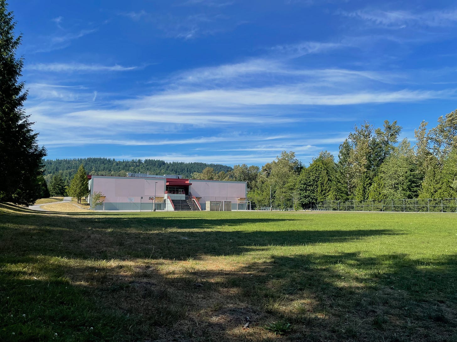 Field with a school in the background