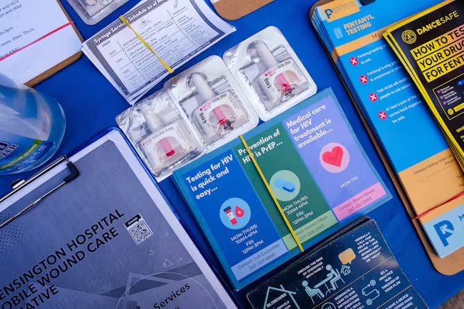 Various papers, brochures and flyers related to opioid addiction are organized on a blue table