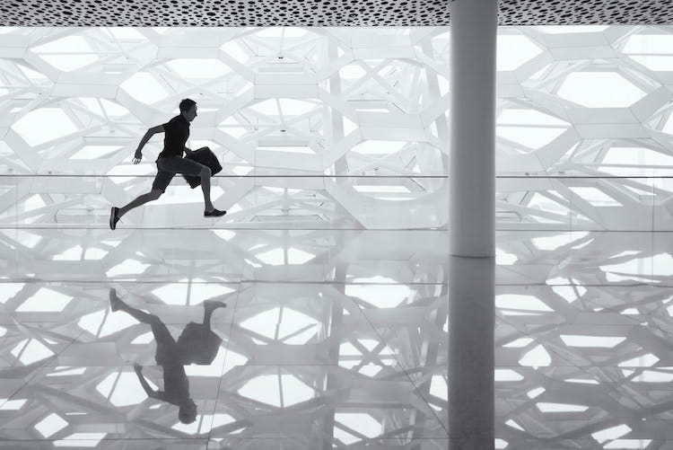 A man running in an airport carrying a bag, credit Andy Beales A man running in an airport carrying a bag, credit Andy Beales
