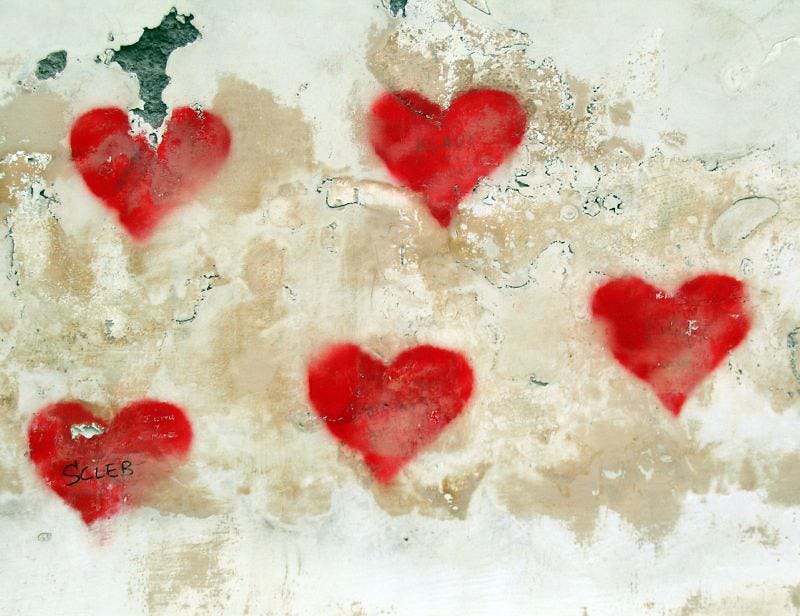 Six red hearts in graffitti on an old city wall; credit: Art Crimes