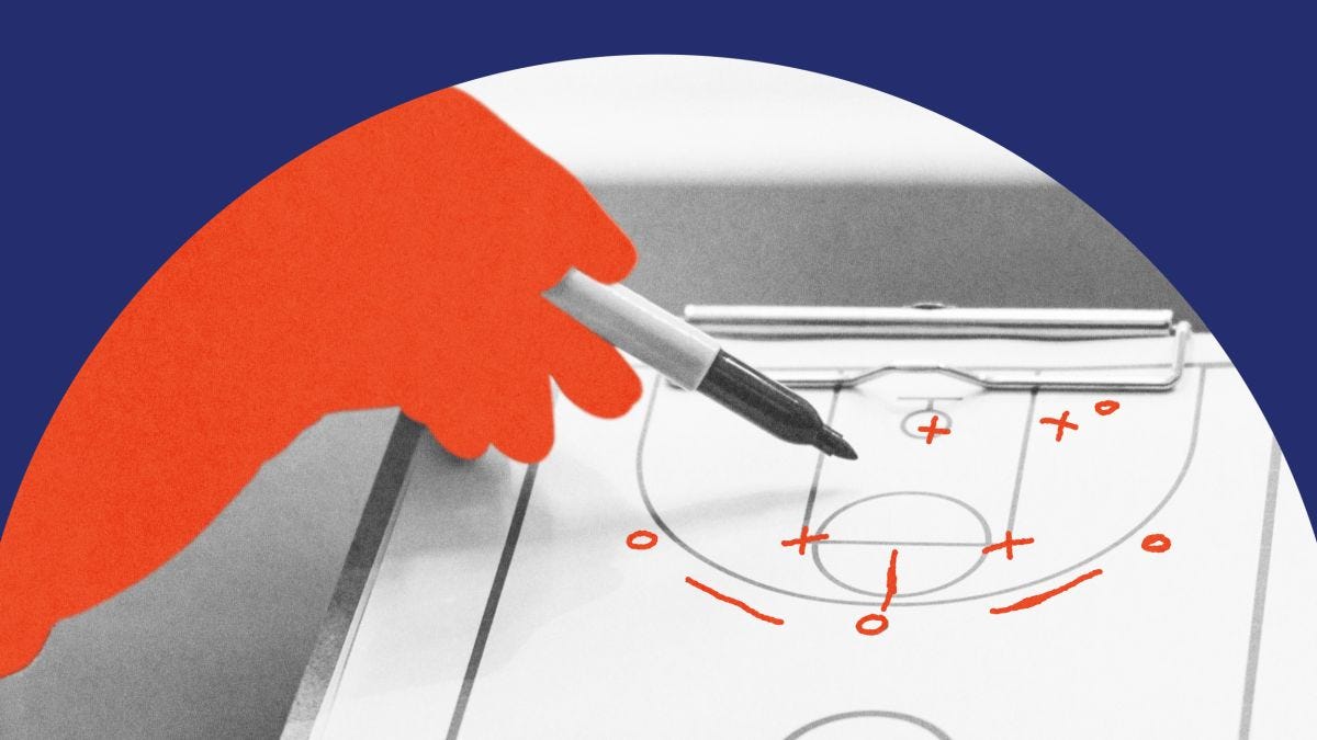 A red-tinted hand holding a marker draws basketball plays on a clipboard with a court diagram, against a blue and white background.