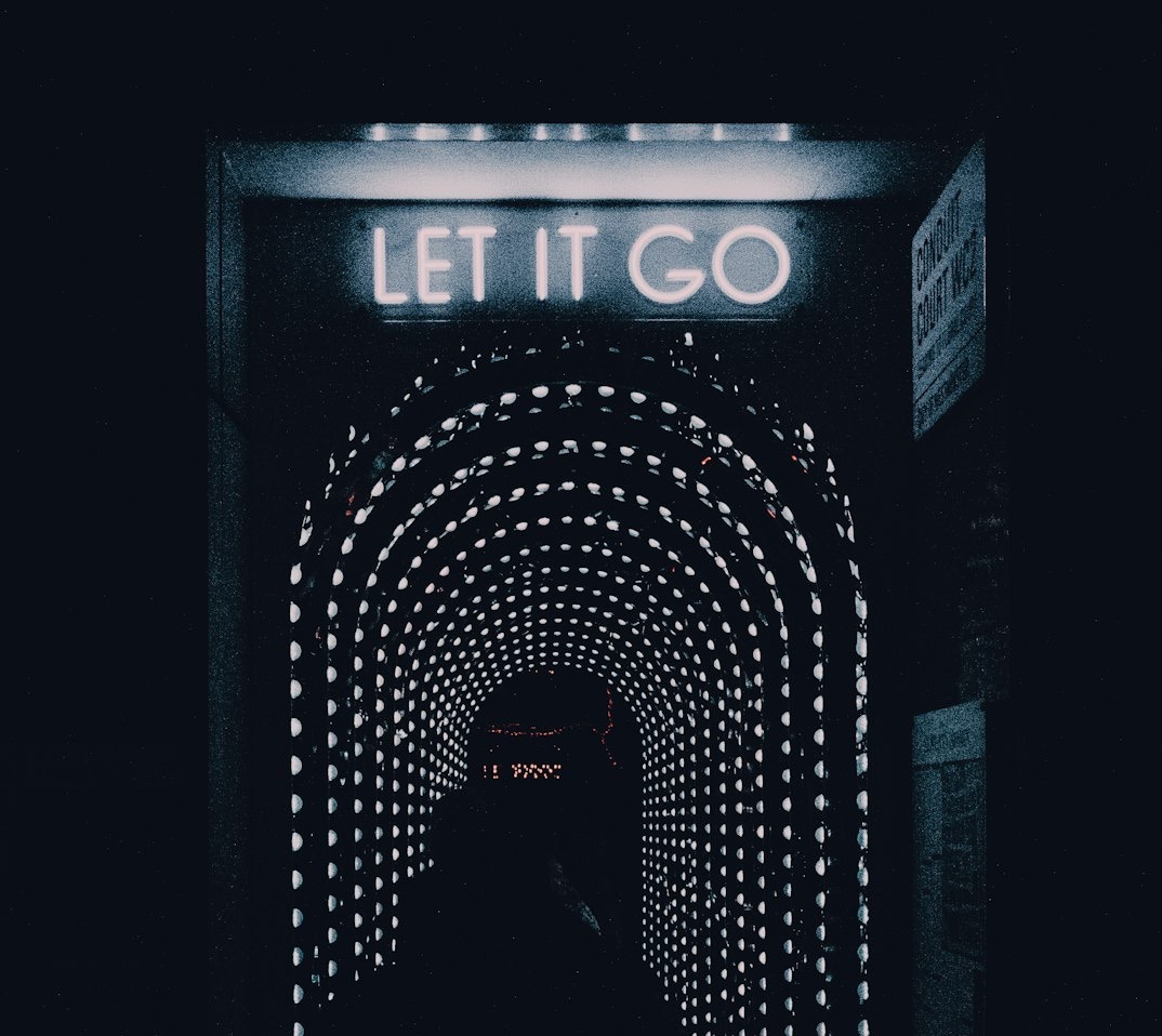 a dark tunnel with a sign that says let it go