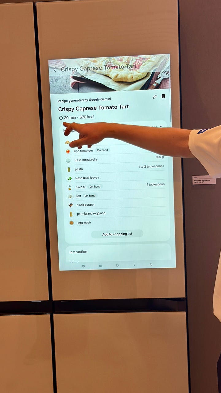 A Samsung AI Family Hub refrigerator displays a recipe for Crispy Caprese Tomato Tart on its touchscreen, while a person points to the ingredient list.