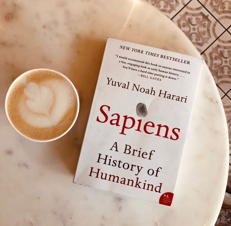 This may contain: a book sitting on top of a table next to a cup of coffee