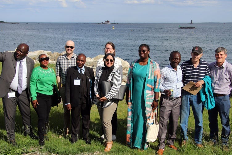 A photo of a group of people set against the backdrop of the Gulf of Maine