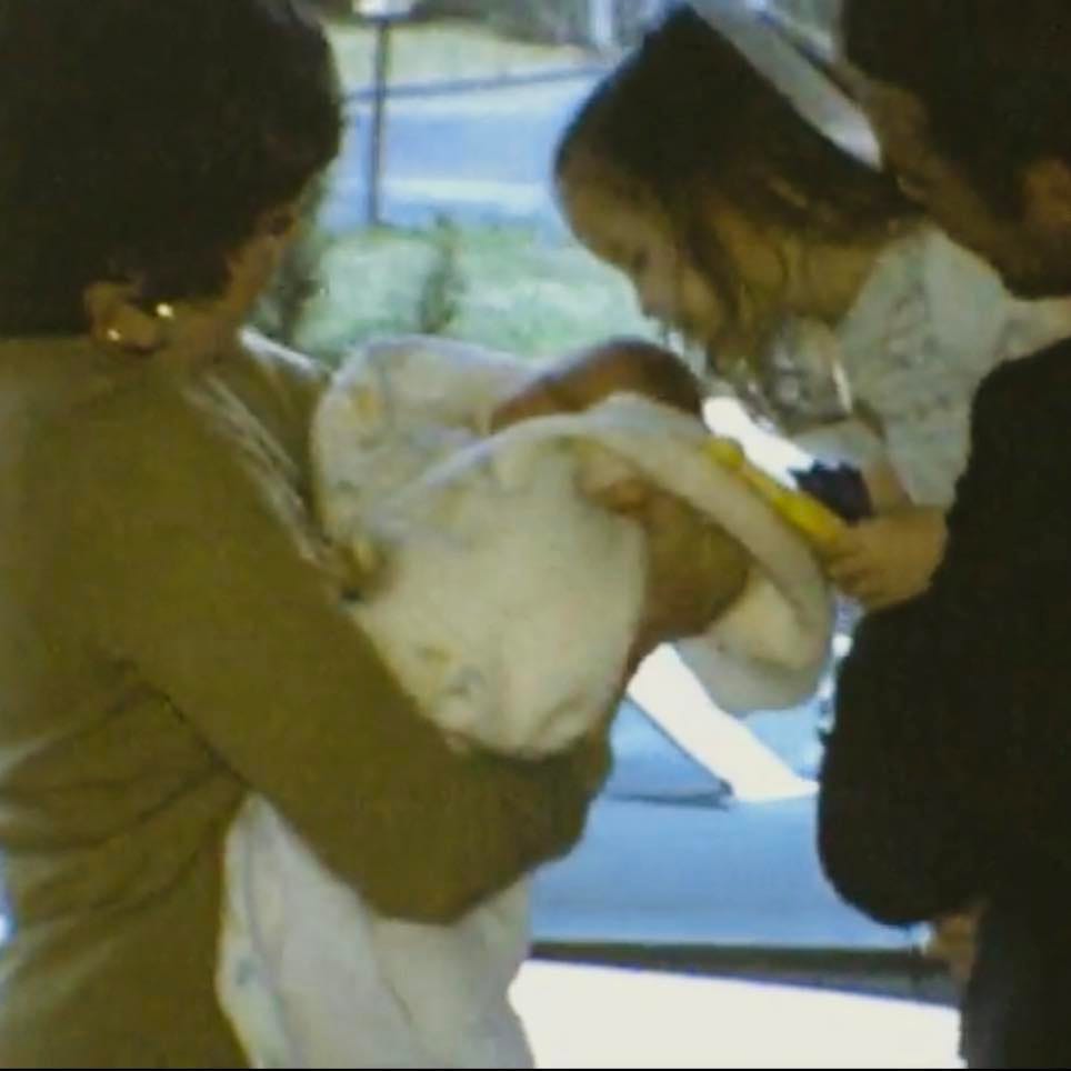 1975, four days old, held by my mom, dad is holding my 4 y/o sister who is seeing me for the first time.