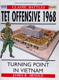 Cover of Tet Offensive 1968: Turning Point in Vietnam by James R. Arnold. The design features a detailed illustrated diorama of a military compound under attack, with a soldier in green combat gear holding a rifle on the left side. The title is in bold black text, with red and white accents.