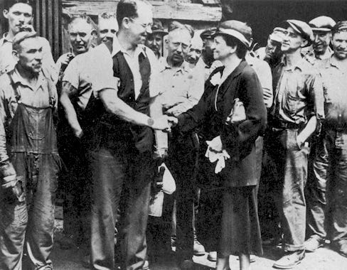 group of white men, industrial workers, with Secretary of Labor, Frances Perkins