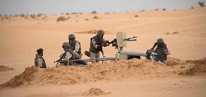 Soldiers stand guard at a G5 Sahel task force command post on Nov. 22, 2018, in Mauritania near the border with Mali. Soldiers stand guard at a G5 Sahel task force command post on Nov. 22, 2018, in Mauritania near the border with Mali.