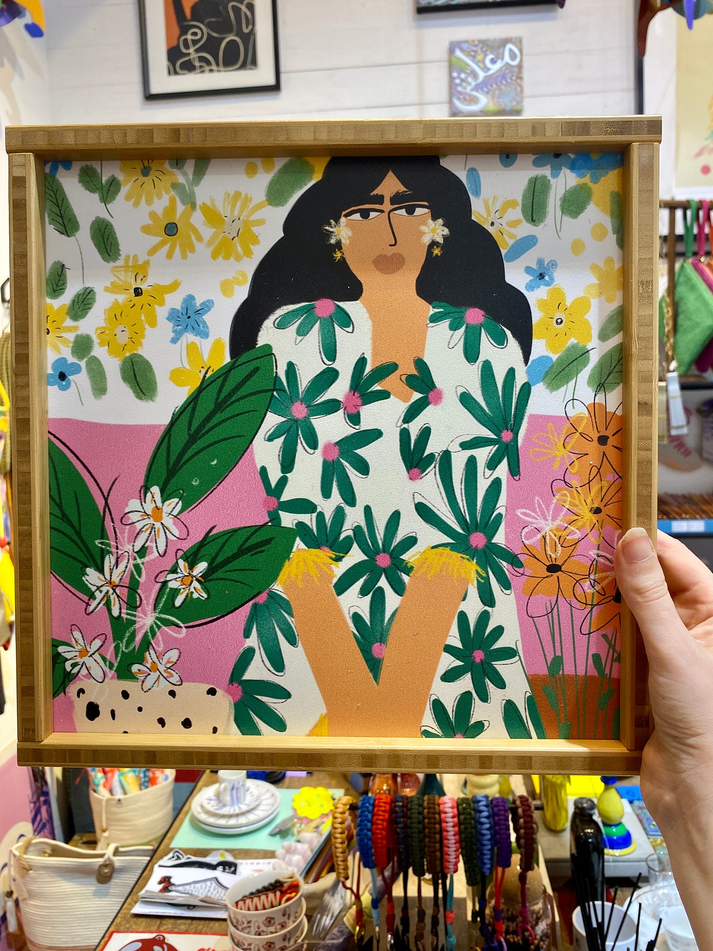 A hand-painted tray with a woman and flowers.