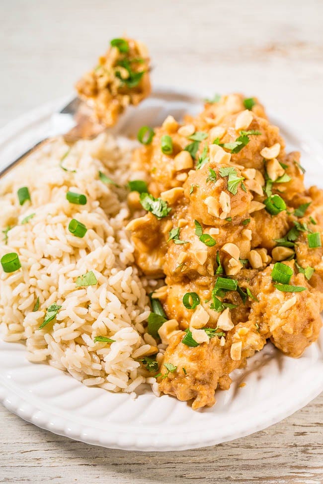 Thai Peanut Chicken on bed of rice with fork. 