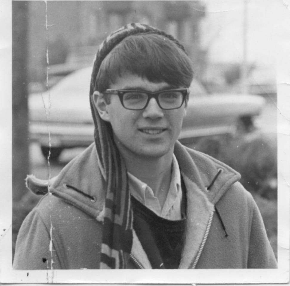 Young Gregg with his preferred Oxford cotton shirt and sweater combo.