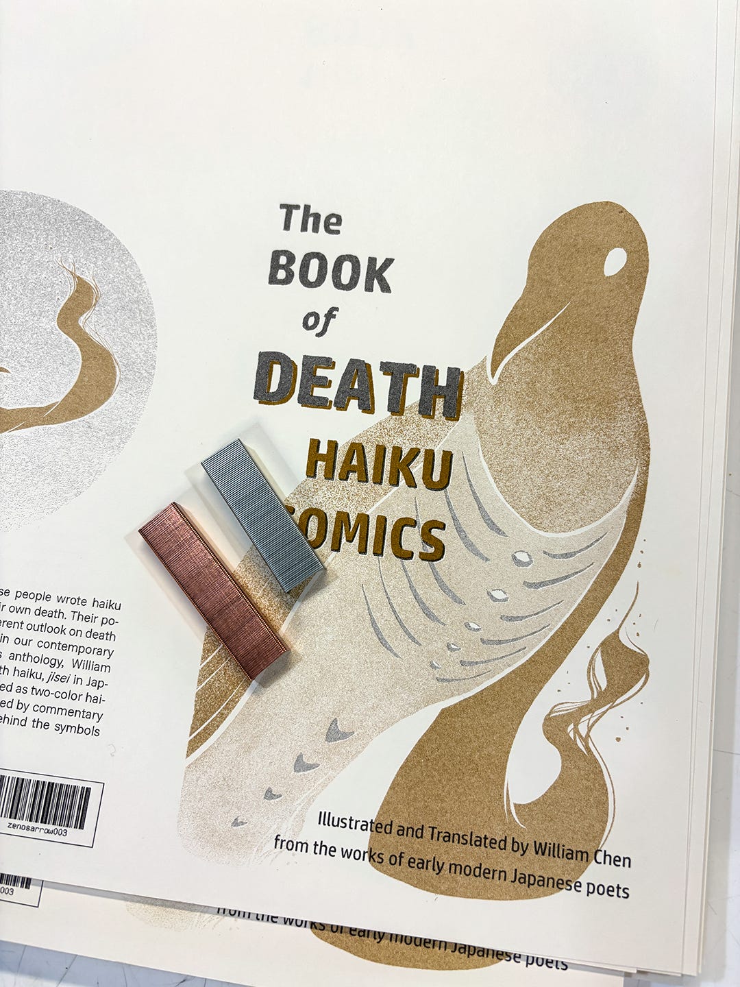 The front and back cover images for The BOOK of DEATH Haiku Comics, in-progress at the printers, yet to be cut down to size, with copper and silver staples laid on the paper.