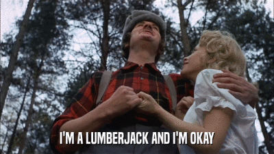 A man in a check shirt and hat with a woman sings