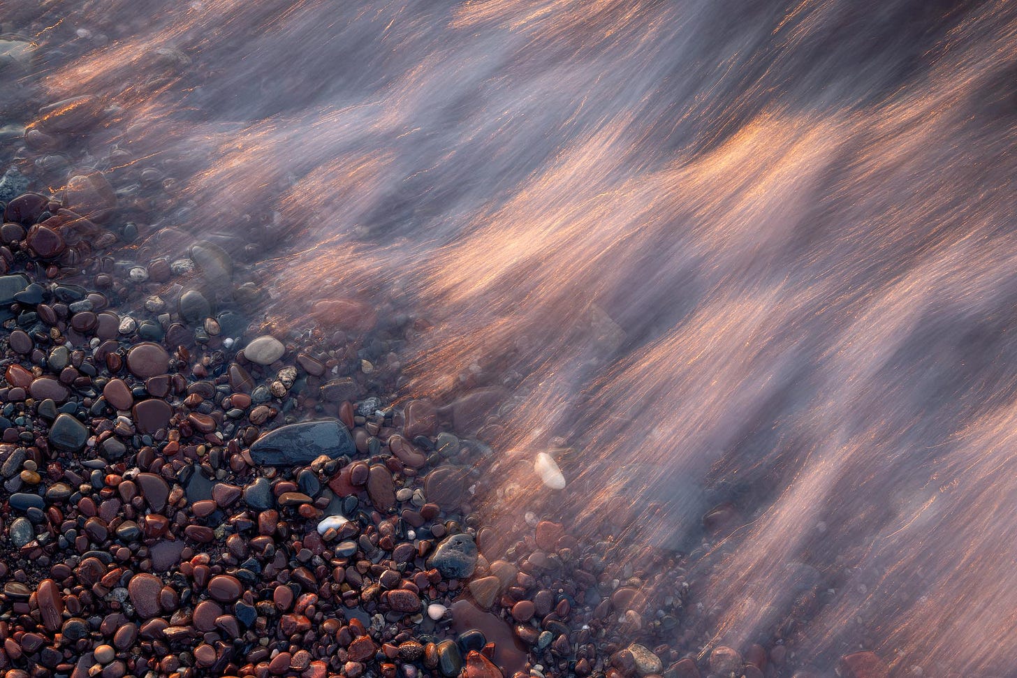 Shoreline Waves The last light of the day hits the top of gentle waves along the shore of Lake Superior. Porcupine Mountains, Michigan.