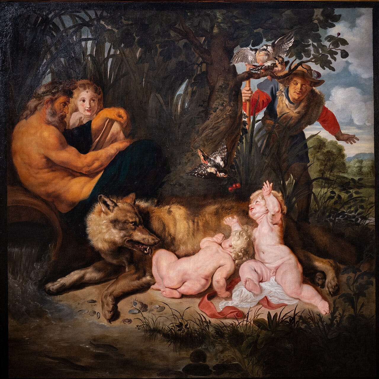 A she wolf suckling two infant boys as a river god watches