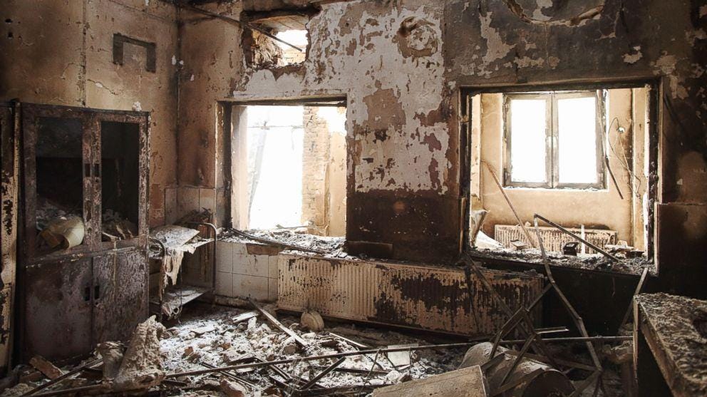 A room with broken windows and debris

Description automatically generated