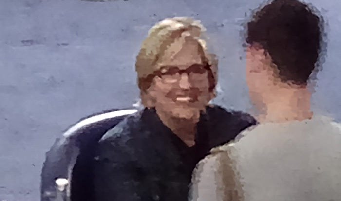 Pixelated image of Brene Brown smiling at a fan during a book signing