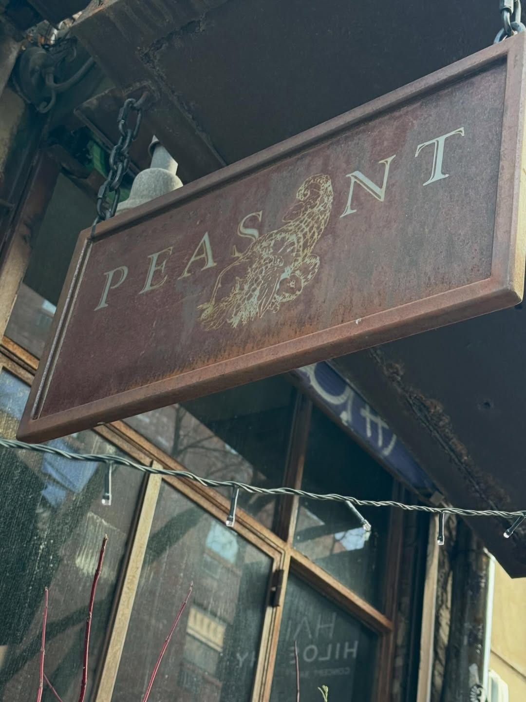 Peasant's restaurant sign in brown with white lettering and picture of a peasant Peasant's restaurant sign in brown with white lettering and picture of a peasant