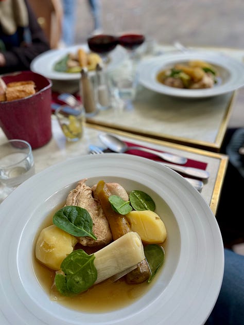 Chicken dish. People toasting. A table with a view