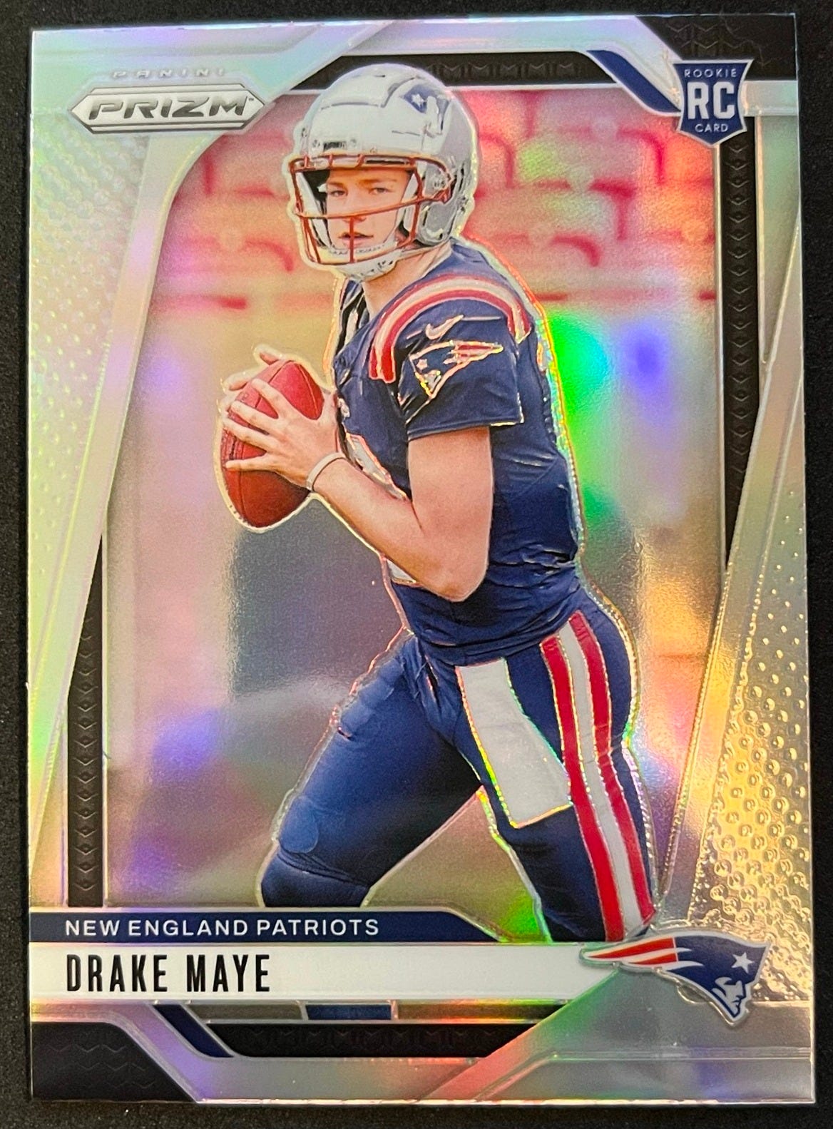 Example of about 60/40 top bottom centering for PSA grading on 2024 Drake Maye Prizm Silver Rookie Card #329. Example of about 60/40 top bottom centering for PSA grading on 2024 Drake Maye Prizm Silver Rookie Card #329.