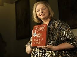 Hilary Mantel holding a copy of her historical novel "Wolf Hall"
