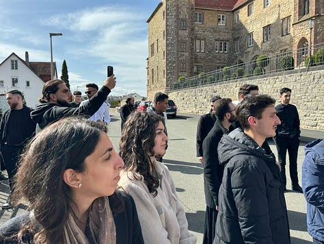 A number of people taking a walk and posing for photos