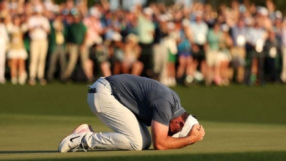 Rory McIlroy on his knees on the 18th green, head in his hands, overwhelmed with relief after holing the winning birdie putt at the Masters.