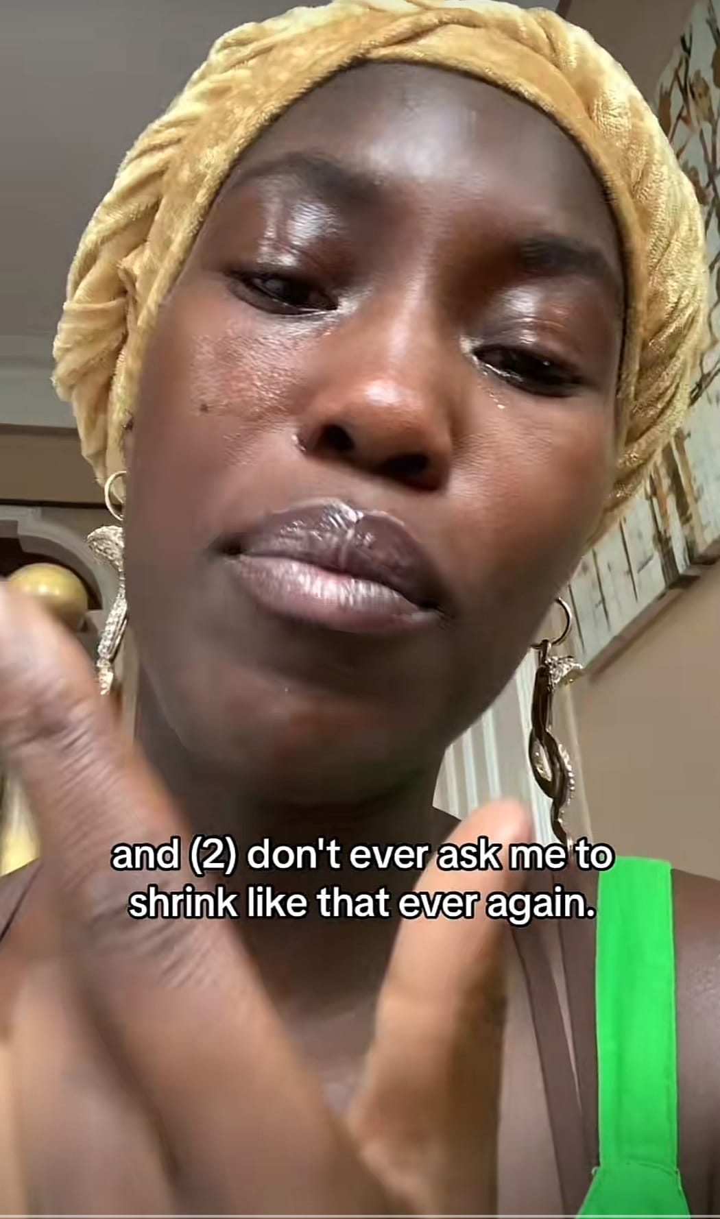 Ismatu in 2023 with tears on their face in a gold headwrap, chastising their audience for pushing them towards individualistic mindsets when they announced they would work for free. Ismatu in 2023 with tears on their face in a gold headwrap, chastising their audience for pushing them towards individualistic mindsets when they announced they would work for free.