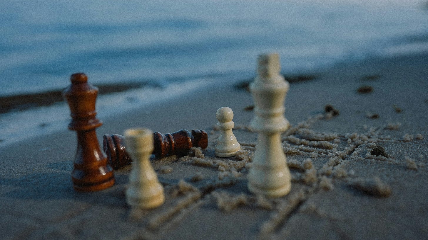 chess pieces on the beach