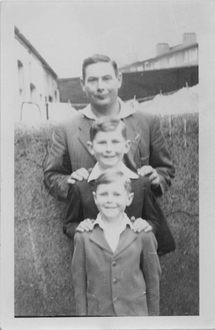 Black and white 1960s picture of father & his two sons Black and white 1960s picture of father & his two sons