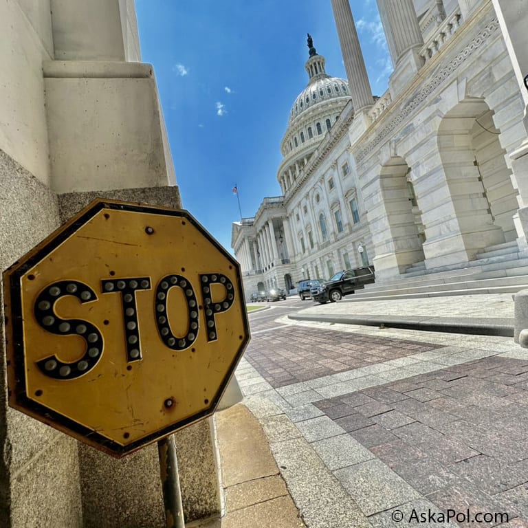 A yellow STOP sign outside US Capitol on sunny blue sky day Photo: Matt Laslo © www.askapol.com