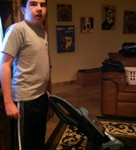 a distant whale tail, snow in the desert, a young boy vacuuming