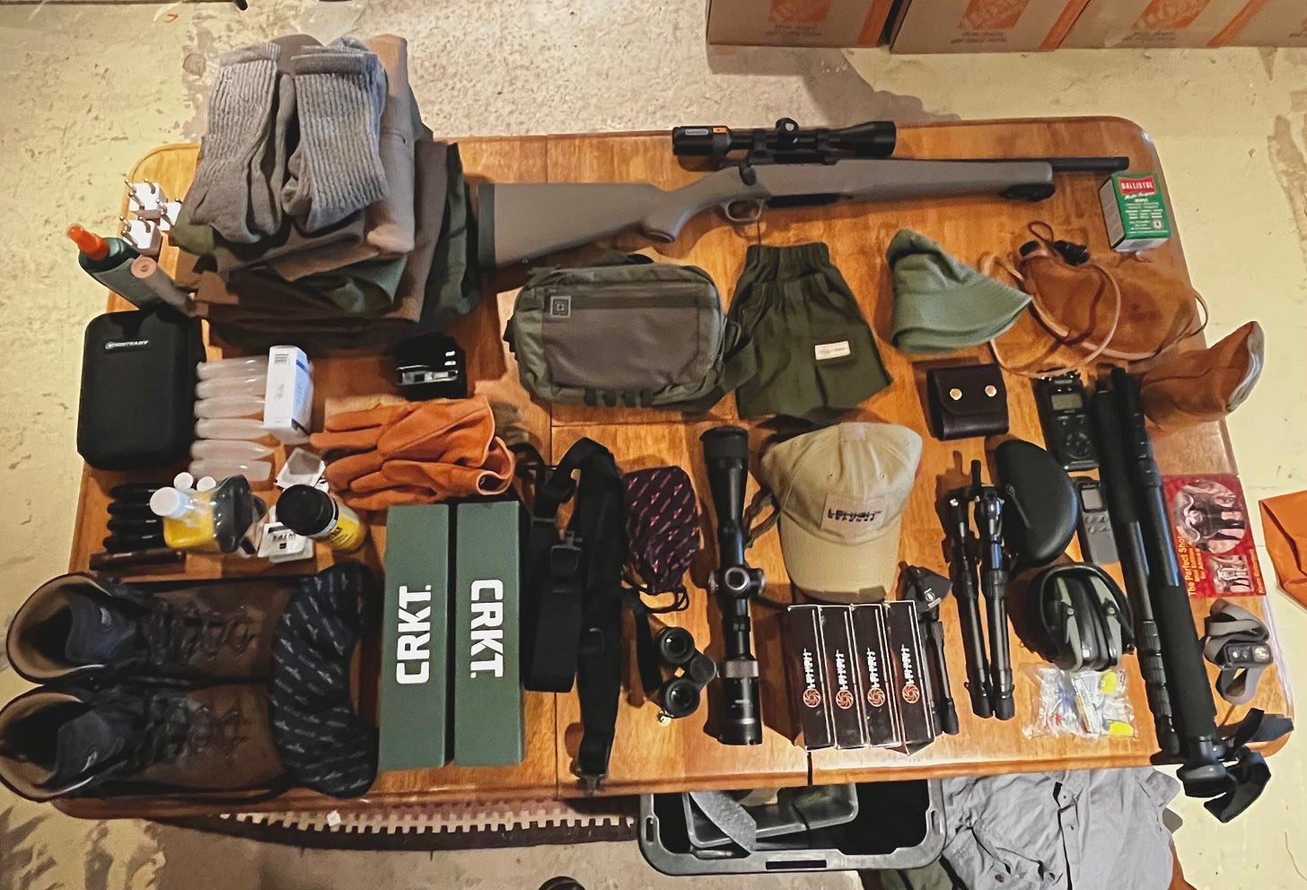 hunting gear on laid out on a table. 