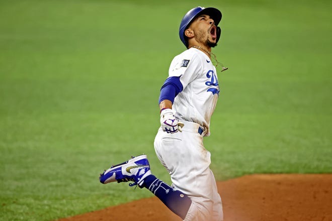 Los Angeles right fielder Mookie Betts celebrates after hitting a home run during the eighth inning against the Tampa Bay Rays during game six of the 2020 World Series.