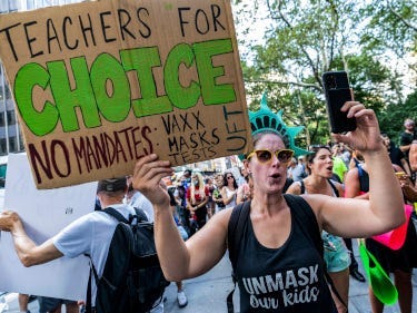 A group of people holding signs

Description automatically generated