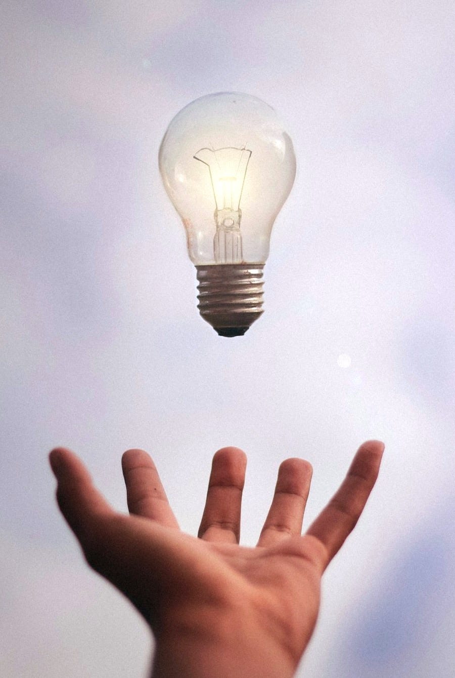 person catching light bulb person catching light bulb