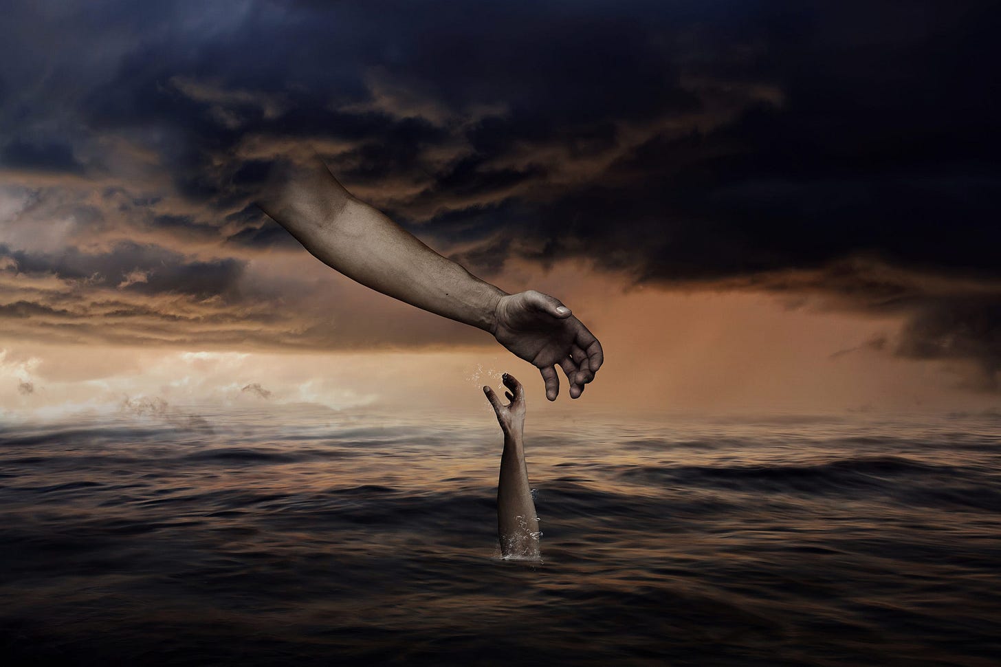 Hand of God reaching down to save drowning man; we only see the hand of the man coming out of the water Hand of God reaching down to save drowning man; we only see the hand of the man coming out of the water
