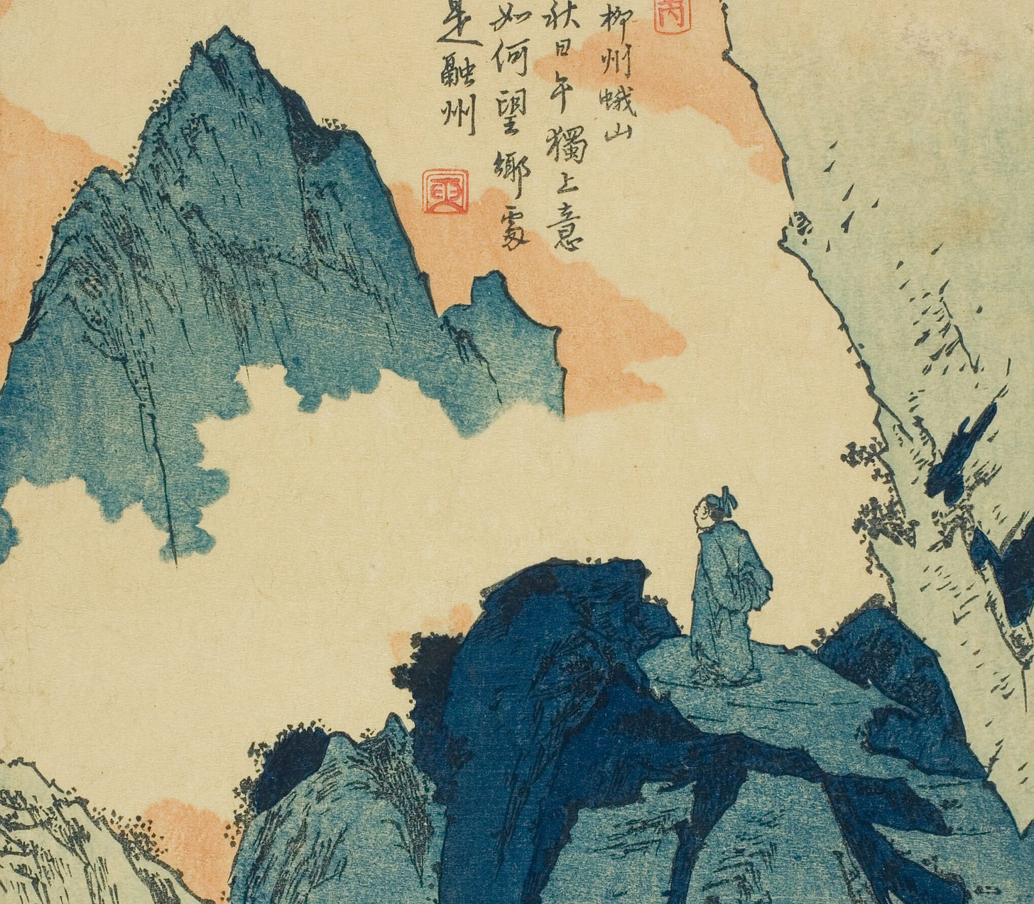 A man standing on a mountain looking at another mountain nearby.
