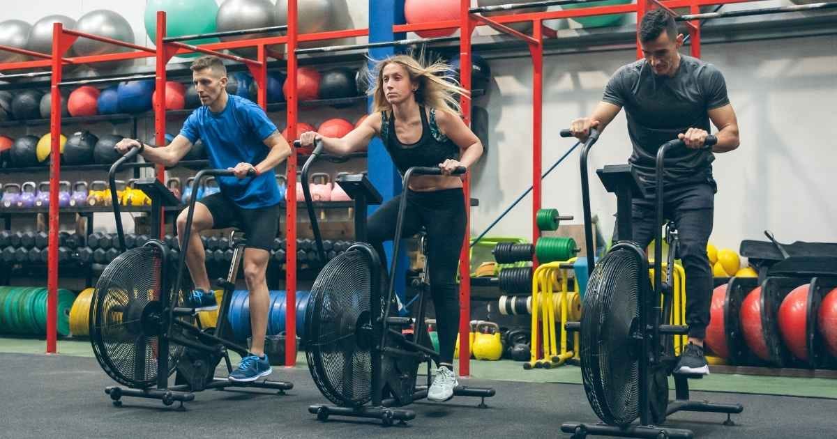 Athletes doing air bike in the gym