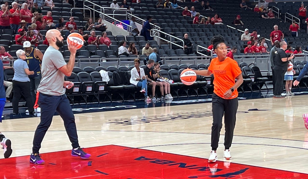 Austin Kelly (left) and Briann January warm up the Sun before their game in Indy.
