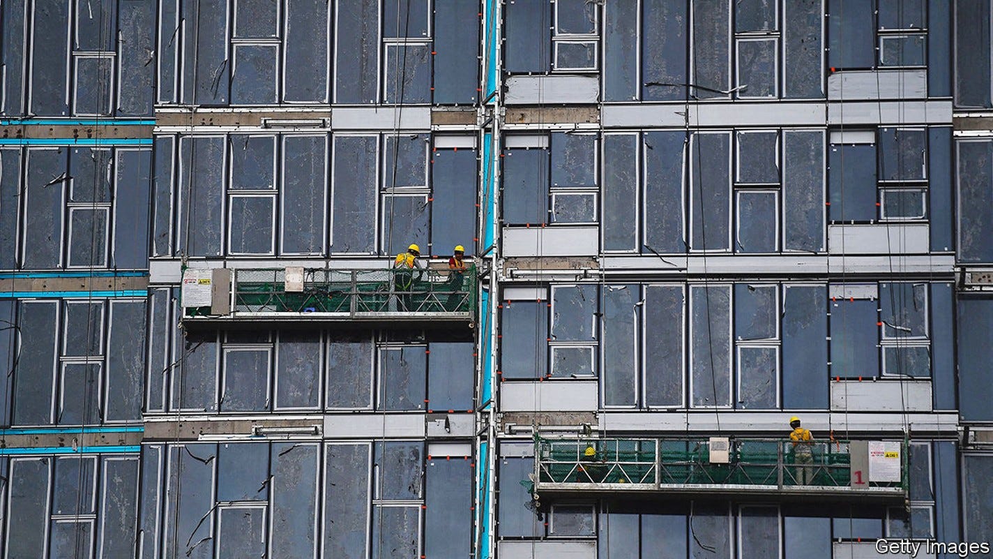 Workers are suspended on the side of an apartment building construction site in Ho Chi Minh City on September 22, 2022. (Photo by Nhac NGUYEN / AFP) (Photo by NHAC NGUYEN/AFP via Getty Images)