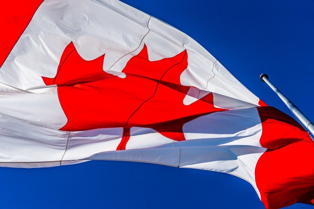 white and red flag under blue sky during daytime white and red flag under blue sky during daytime