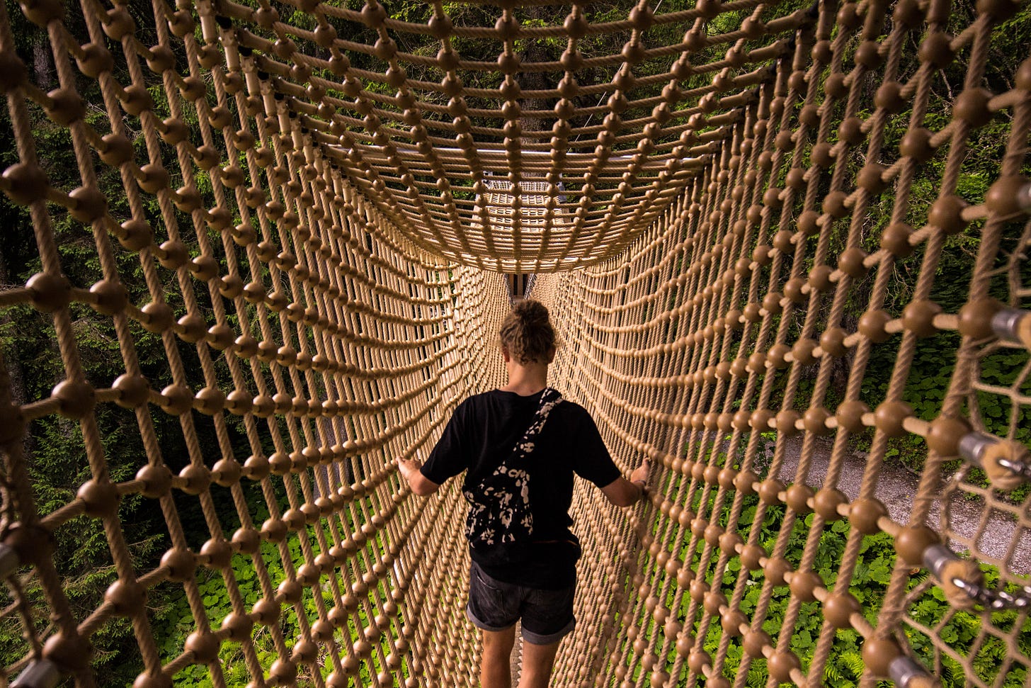 Person climbing in a hanging net Person climbing in a hanging net
