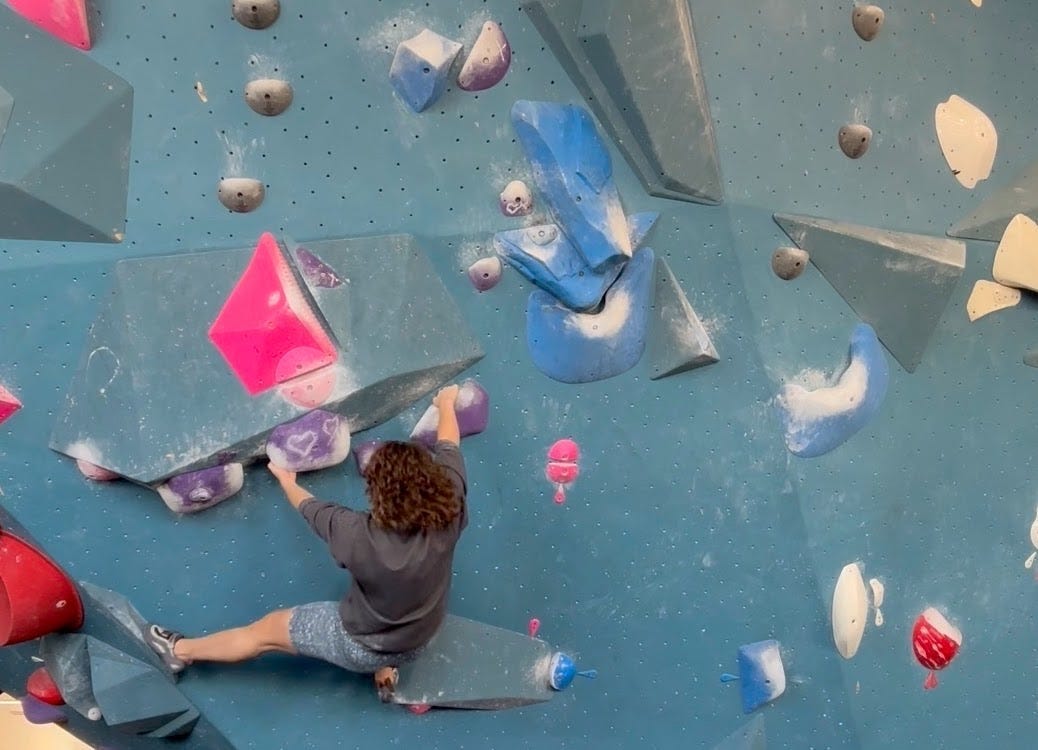 Woman rock climbing at an indoor gym