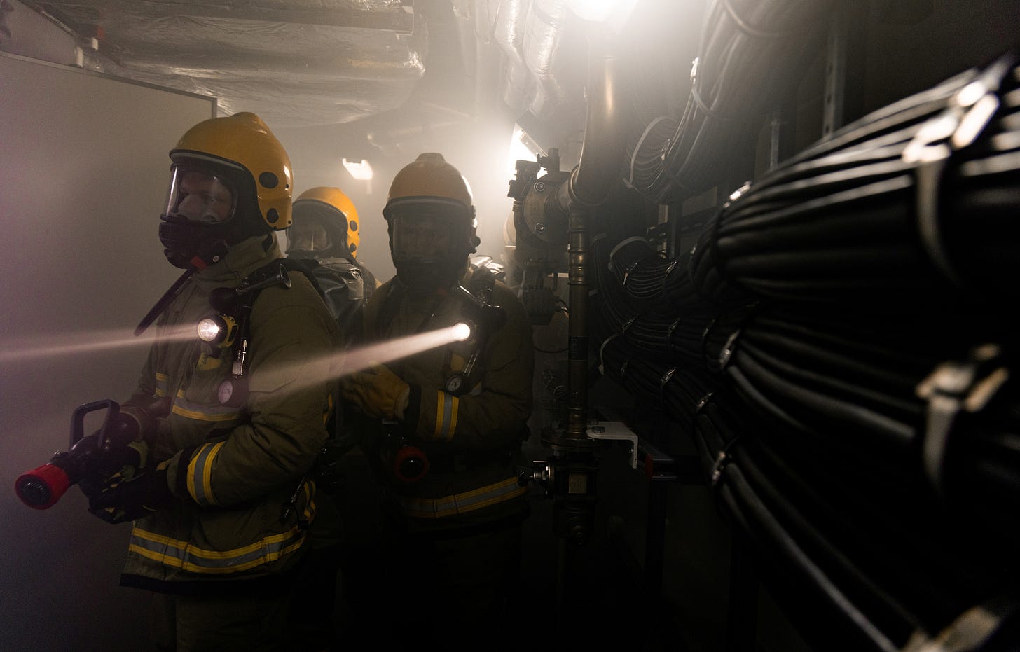 Royal Navy sailors in Fire Fighting Equipment practising Damage Control