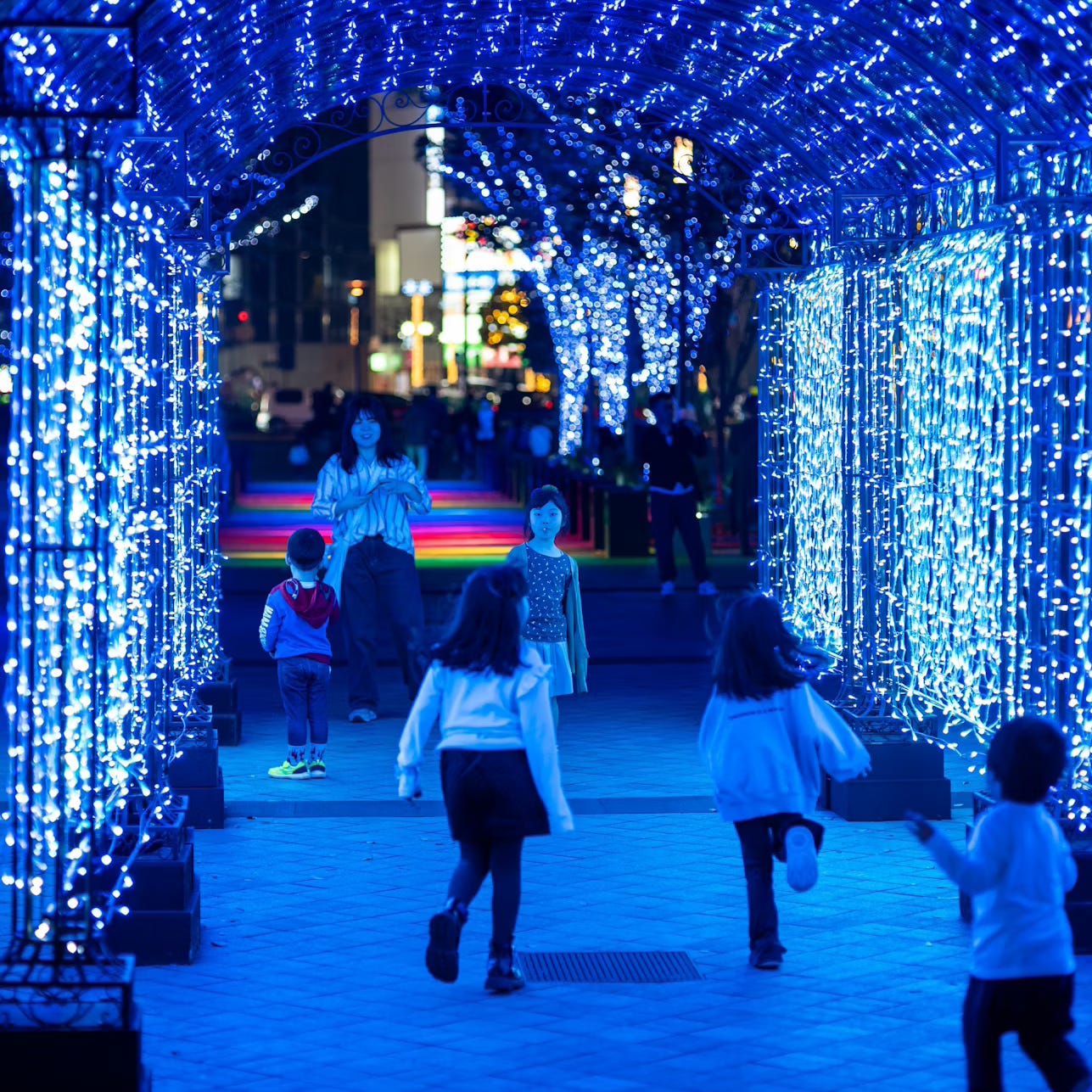Kids Playing in Light Tunnel at Night Kids Playing in Light Tunnel at Night
