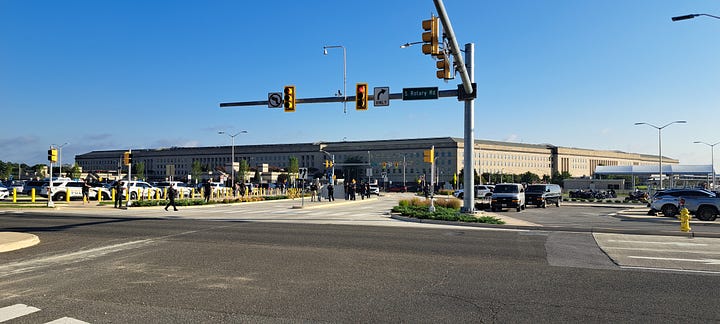 protesters stand on the side of the freeway holding signs commemorating the anniversary of the bombings. 